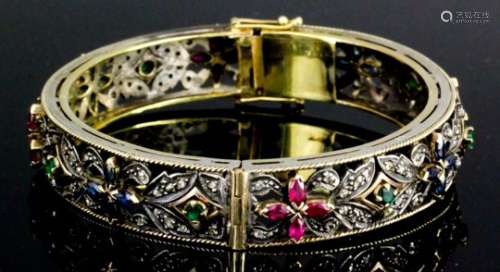 A modern gold and silvery metal mounted diamond, sapphire, ruby and emerald stiff bracelet by Damas,