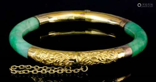 An 18ct gold mounted and jade stiff bracelet, the gold coloured metal mounts cast with bamboo shoots