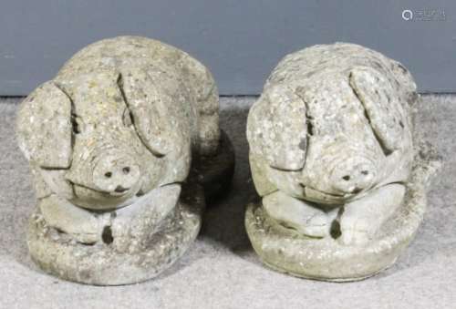 Two moulded cement reclining figures of pigs, on shaped bases, 21ins overall x 10ins high PLEASE
