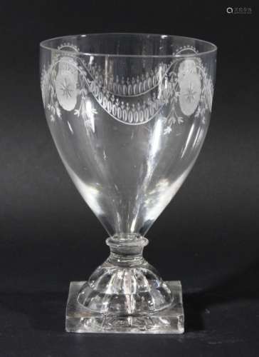 GLASS GOBLET, circa 1800, the tapering bowl with engraved oval and swag decoration, knopped, short