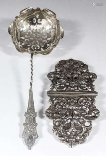 An Edward VII silver nurse's buckle, pierced and cast with leaf scroll ornament, 3.5ins x 2ins
