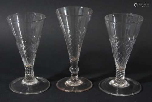 PAIR OF ENGLISH GLASSES, mid 18th century, the conical bowl with wrythen base and stem on