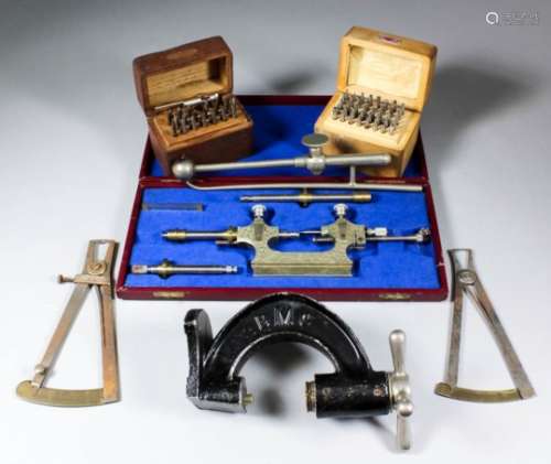A small watchmaker's lathe, and a suitcase containing fitments, drills and clock-making equipment