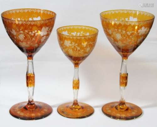 SET OF SIX BOHEMIAN STYLE GLASSES, amber cut through to clear, the rounded bowls engraved with