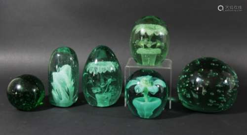 COLLECTION OF SIX GREEN GLASS DUMPS OR ORNAMENTS, to include a blue and yellow flower in a pot,