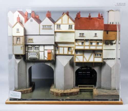 A painted wood cased model of the medieval London Bridge, showing timber framed buildings and a