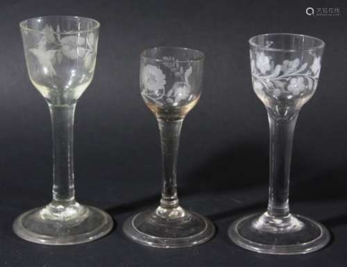 GROUP OF THREE WINE GLASSES, circa 1760, the ogee bowls with floral and bird engraved decoration