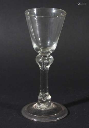 WINE GLASS, circa 1760, the rounded funnel bowl above a balustroid stem with shoulder and basal