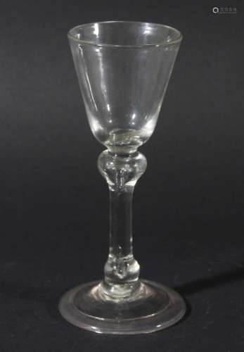 WINE GLASS, circa 1760, the rounded funnel bowl above a balustroid stem with shoulder and basal