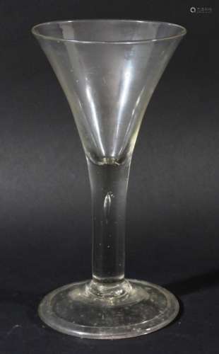 LARGE WINE GLASS, circa 1760, the drawn trumpet bowl above a plain stem with tear on a dome foot