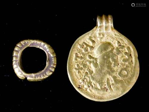 An early Medieval gold Bracteate with triple reeded suspension loop, the obverse in relief with a