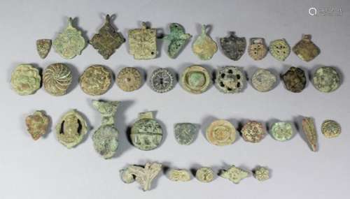 A collection of Medieval and post medieval cast copper alloy and brass harness pendants, badges