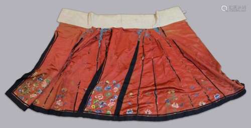 CHINESE SILK SKIRT, late 19th or early 20th century, embroidered with flowers on a red ground, waist