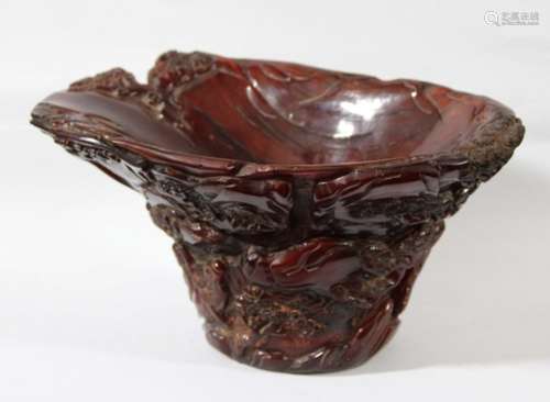 CHINESE BUFFALO HORN LIBATION CUP, carved with figures on a punt amongst pine trees and rocks,