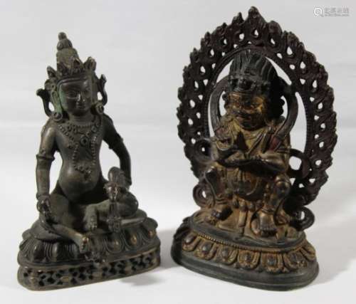 INDO-CHINESE BUDDHISTIC BRONZE FIGURE, seated holding a rat, height 15cm; together with another of a