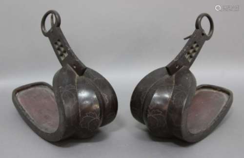 PAIR OF EASTERN BRONZE STIRRUPS, possibly Chinese, inlaid with a foliate design, length 27cm (2)