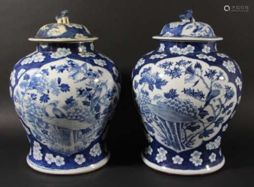 PAIR OF CHINESE BLUE AND WHITE JARS AND COVERS, Kangxi style, of swollen baluster form painted