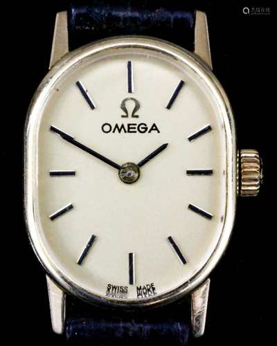 A lady's Omega 14ct gold cased manual wind wristwatch, the oval gold dial with gold baton