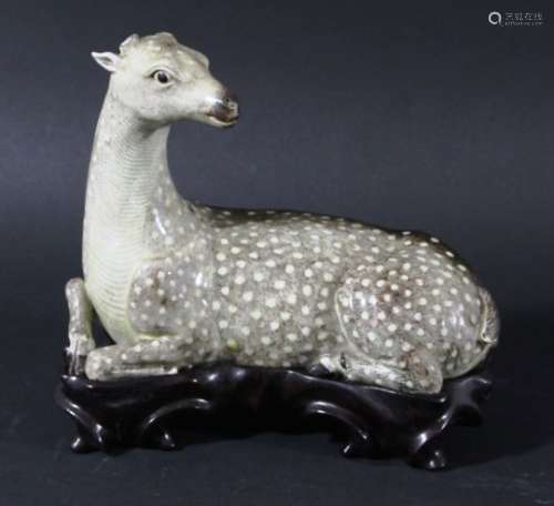 CHINESE PORCELAIN FIGURE OF A RECUMBENT DEER, probably 19th century, with dappled brown fur, lacking