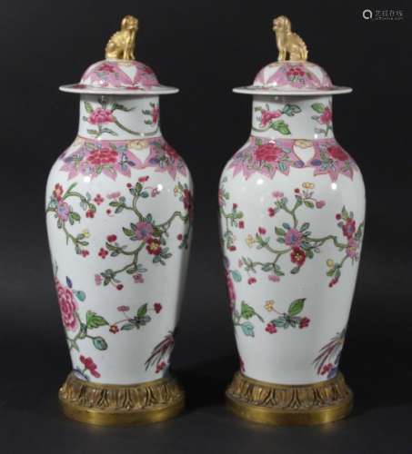 PAIR OF CHINESE FAMILLE ROSE VASES AND COVERS, 19th century, of inverted baluster form enamelled
