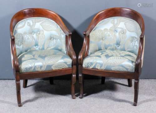 A pair of 19th Century French mahogany framed tub shaped chairs in the Empire manner, with plain