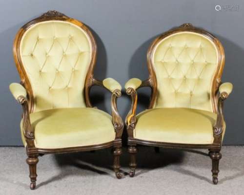 A pair of Victorian walnut framed gentleman's and lady's open arm spoon back easy chairs, the