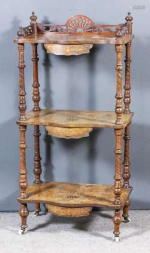 A Victorian walnut rectangular and serpentine fronted three-tier whatnot with shaped and fretted