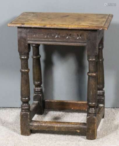 A 17th Century oak joint stool with moulded edge to top, the sides with chip carving and moulded