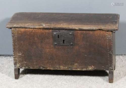 A 17th Century oak small plank coffer with moulded and chip carved edge to top, 21ins wide x 10.