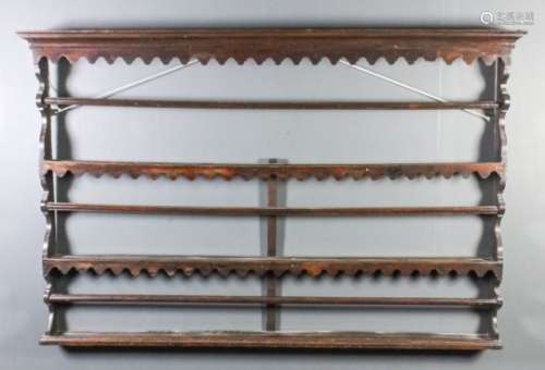 An 18th Century oak Delft rack with moulded cornice and shaped frieze and aprons, on shaped sides