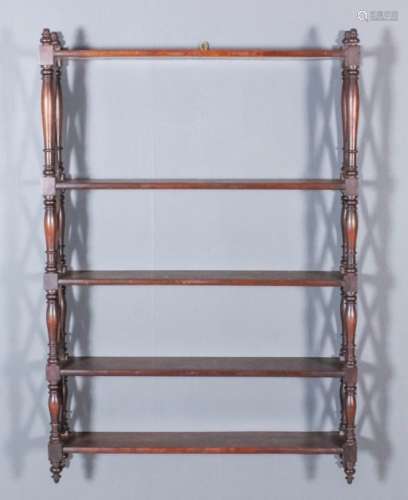 A mahogany five tier wall shelf, with turned uprights and cross pattern ends, 26ins wide x 37ins