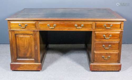 An early 20th Century partners mahogany kneehole desk with dark leather inset to top and moulded