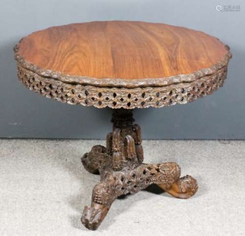 A 19th Century Anglo-Burmese rosewood circular breakfast table, the wavy rim with carved