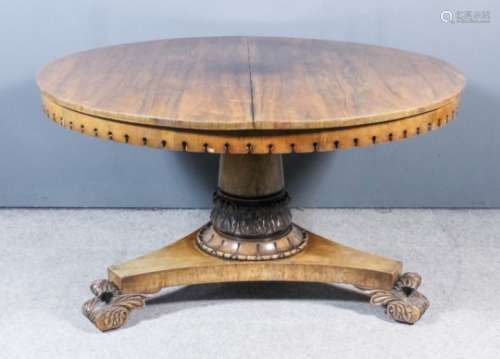 A William IV rosewood circular breakfast table with square edge to top and shaped apron, on turned
