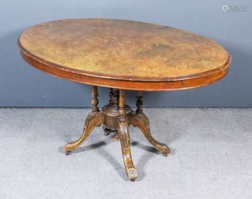 A Victorian figured walnut oval breakfast table, the quarter veneered top with moulded edge inlaid