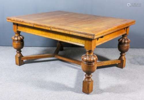 A large oak draw leaf dining table of 