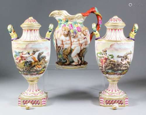 A pair of late 19th Century Continental porcelain two-handled urns and covers, moulded and painted