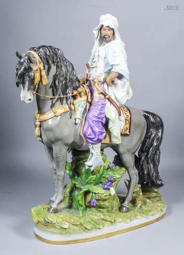 A 20th Century Continental porcelain figure of a mounted Arab horseman, on naturalistic base, 21.