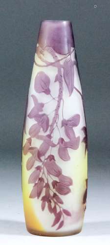 An early 20th Century Galle mauve overlay cameo glass vase of tall slender form, carved with a