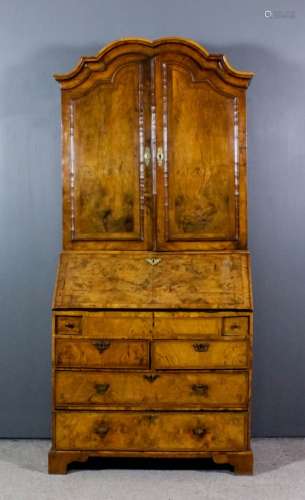 A George II walnut bureau cabinet, the whole veneered in figured walnut and inlaid with