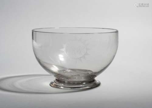 A glass punchbowl c.1770, engraved with the initials 'BMC' within a starburst cartouche, raised on a