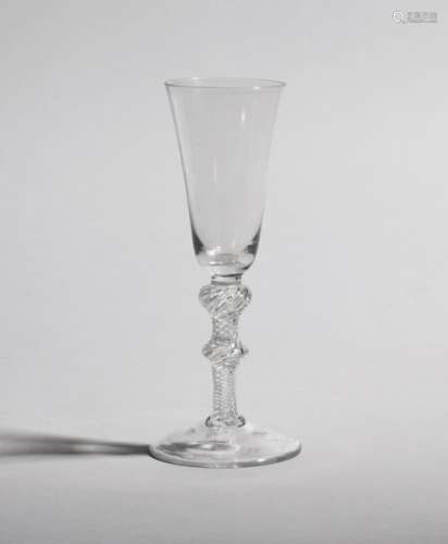 A large ale glass c.1765, with slender round funnel bowl raised on a double knopped airtwist stem