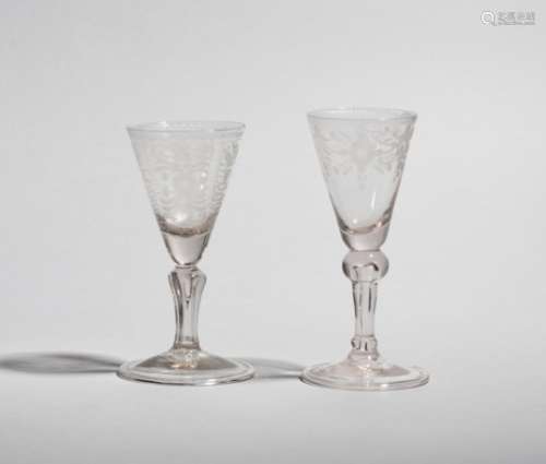 Two Dutch wine glasses mid 18th century, the flared funnel bowls engraved with stylized flowers