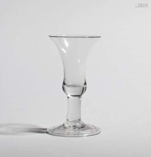 An unusual wine glass c.1750-60, a bell bowl raised on a short, thick stem above a conical folded