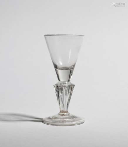 A wine glass c.1740, the rounded funnel bowl raised on a six-sided Silesian stem above a folded