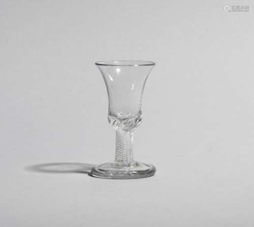 A rare firing glass c.1760, with an unusual bell bowl raised on a thick airtwist stem above a