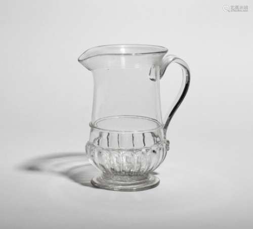 A glass jug, c.1780-1800, the bell shape with gadroon moulding around the base, the everted rim