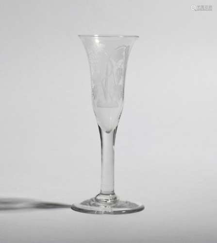 An ale glass or wine flute c.1760-70, the elongated bell bowl engraved to one side with crossed