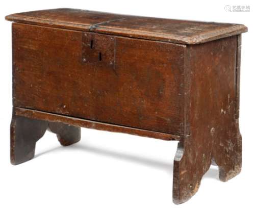 A small early 17th century oak boarded coffer, the lid with a moulded edge and branded with initials