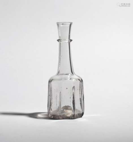 A small cruciform glass serving bottle or decanter c.1740, the squat heavy body rising to a